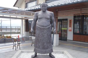 Statue of Raiden Tameemon, the legendary undefeated sumo wrestler of the Edo period, wearing a traditional kesho-mawashi.