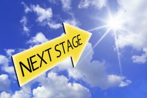 A bright yellow arrow labeled “NEXT STAGE” pointing toward the shining sun in a blue sky, symbolizing progress, awakening, and the transition to a new stage of civilization.