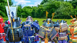 A group of samurai in traditional Japanese armor stands side by side on a green field, recalling the Sengoku period and the values of honor, loyalty, and duty.